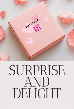 Pink box with 'Luxe Revelry Box' text and heart designs on a light background with pink petals.